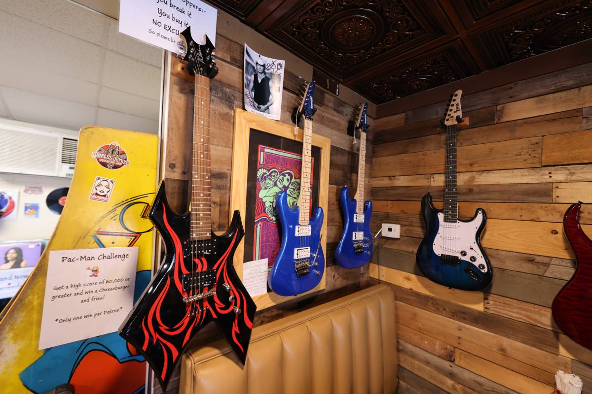 Guitar wall with electric guitars on reclaimed wood